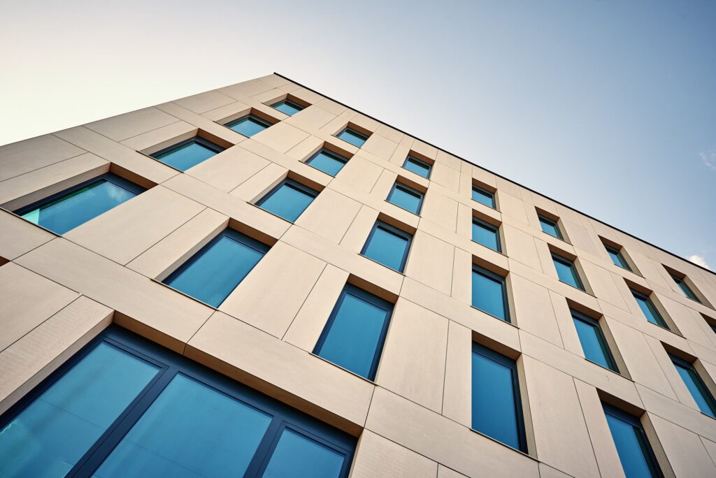Modern building facade featuring blue windows, showcasing Clearview Windows & Doors.