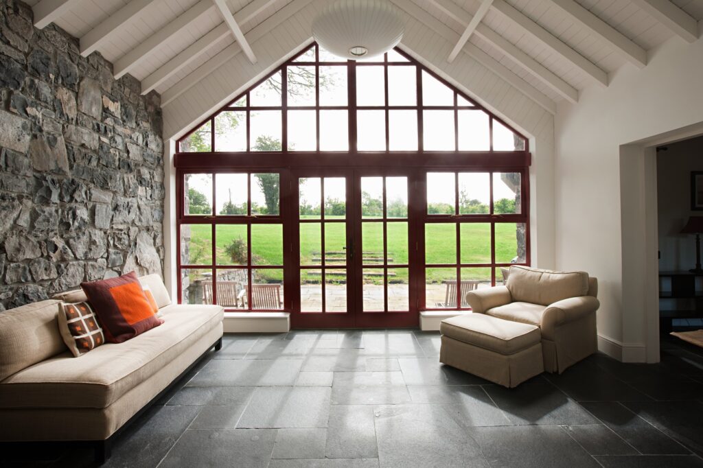 A cozy living room featuring a large window and a fireplace, showcasing Clearview Windows & Doors products.