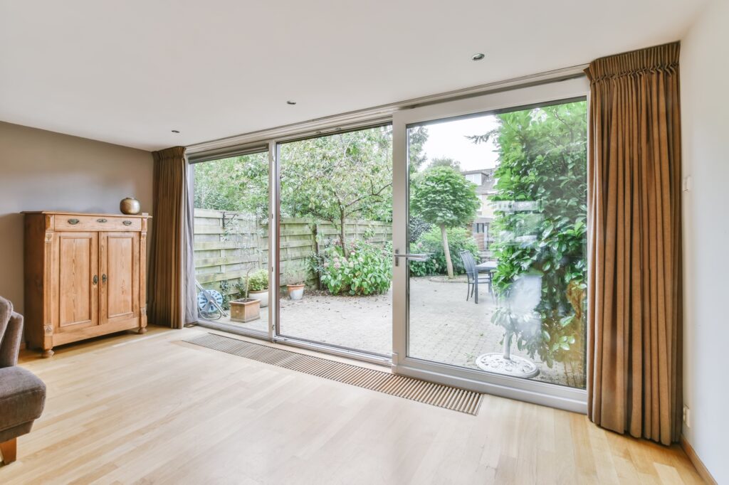 Living room featuring sliding glass doors and wooden floors, showcasing Clearview Windows & Doors products.